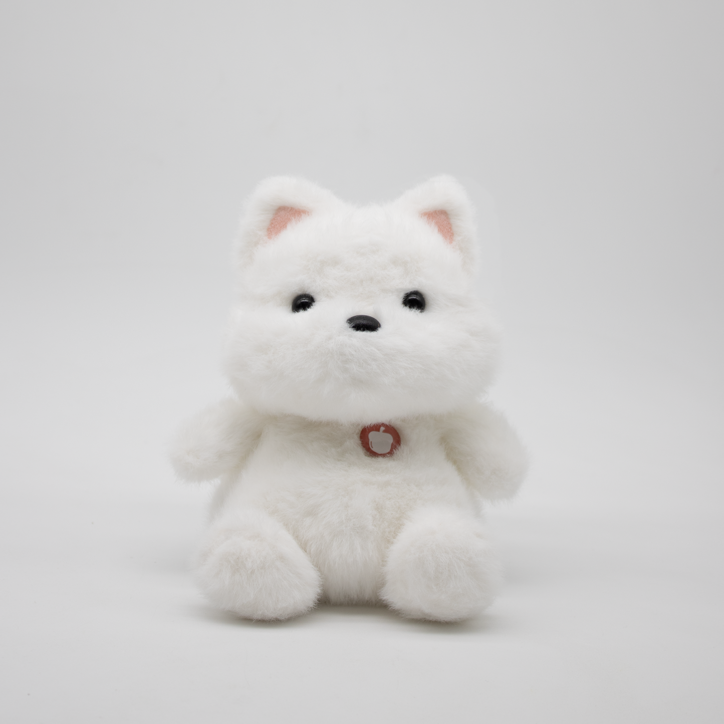 White plush puppy on a light background