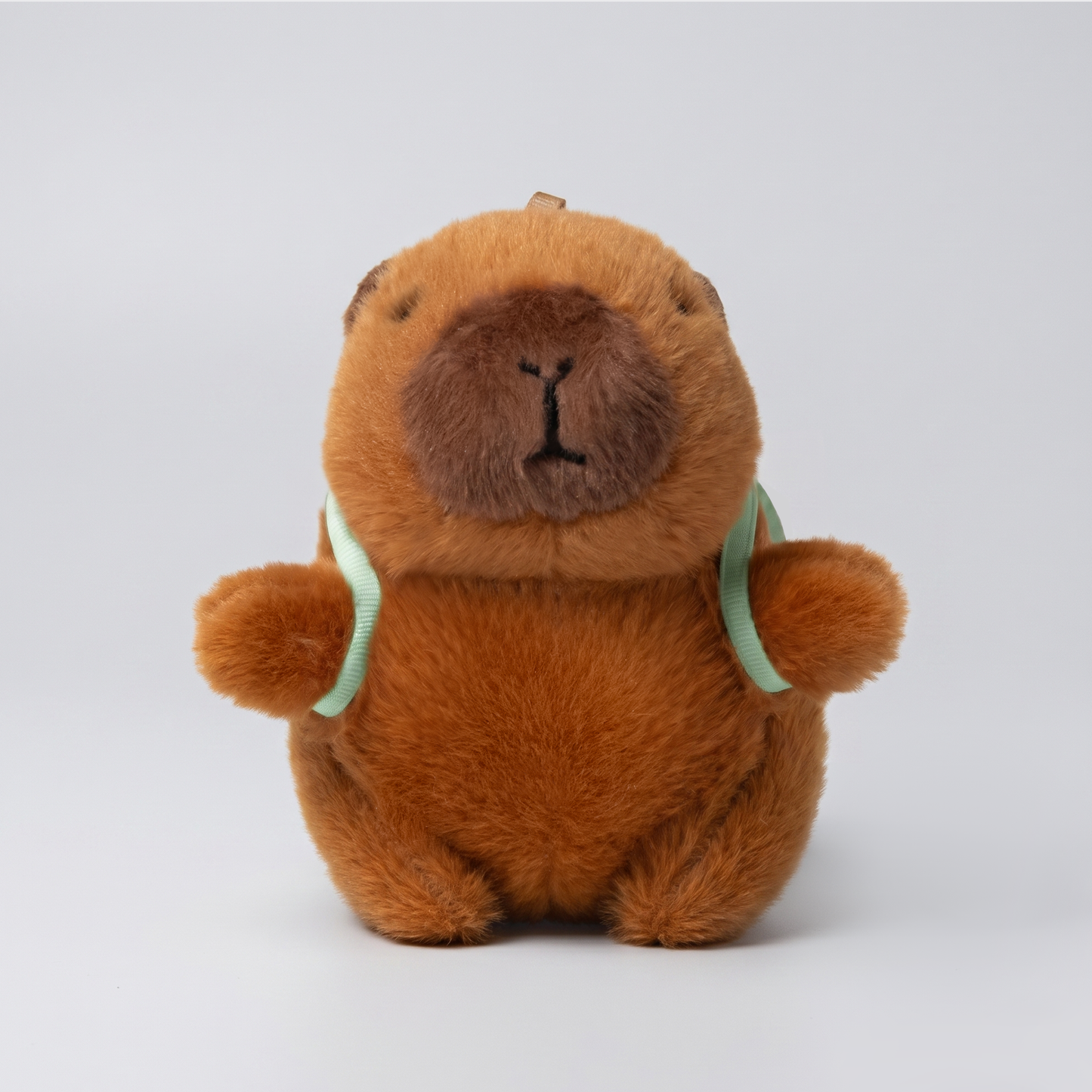Soft capybara plush keychain wearing a backpack 