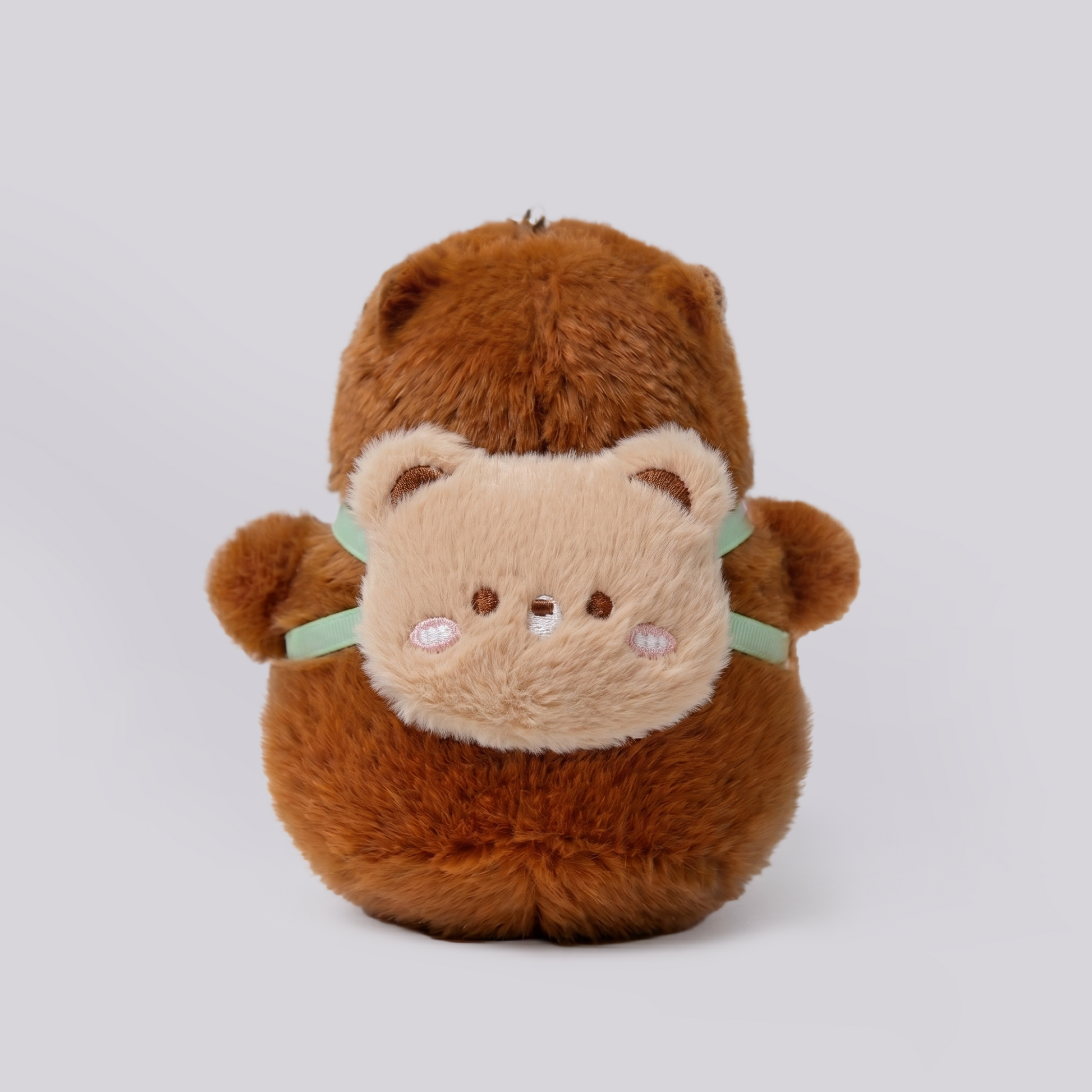 Soft capybara plush keychain wearing a cute bear shaped backpack 