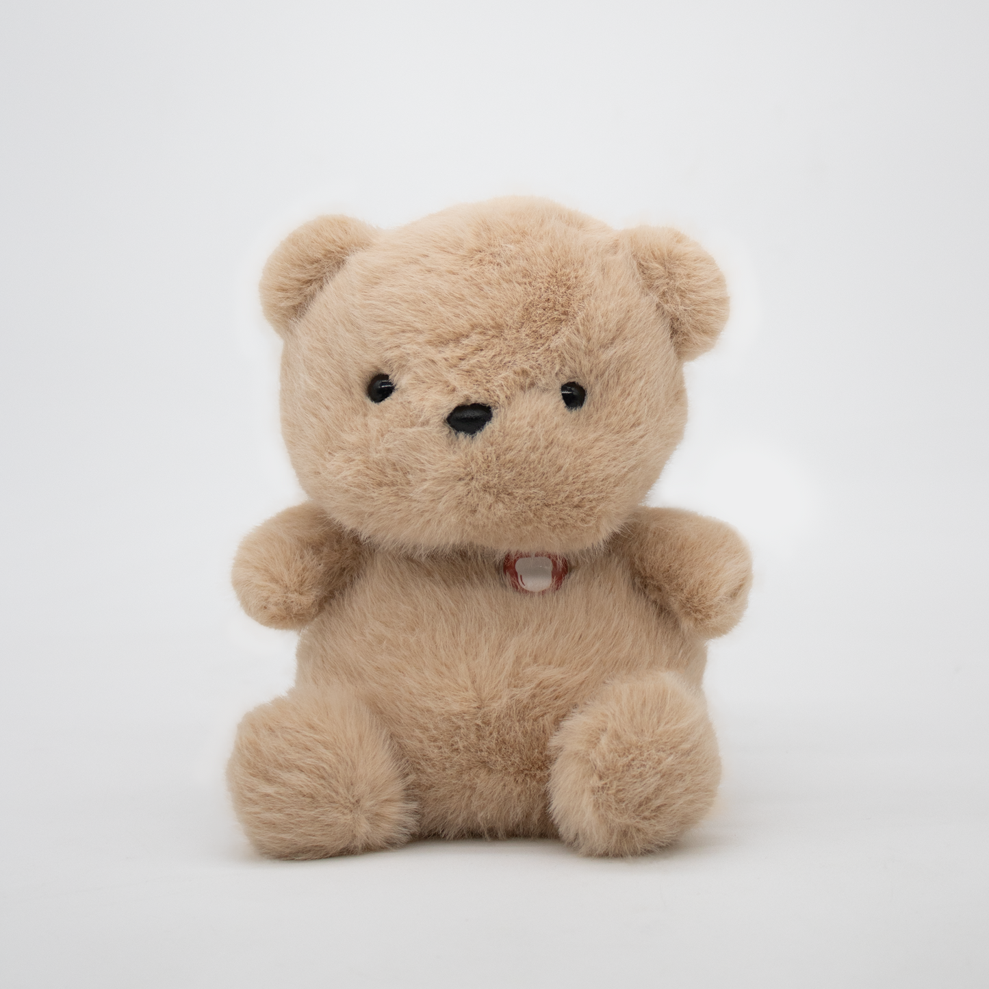 Beige teddy bear plush on a white background