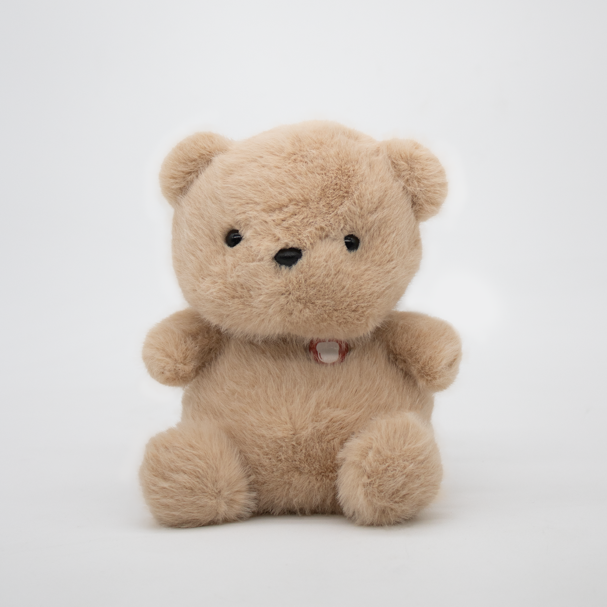 Beige teddy bear plush on a white background