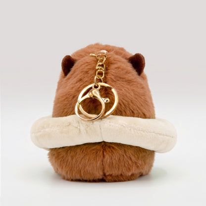 Fluffy capybara plush toy wearing a cream floatie ring featuring a gold metal key ring