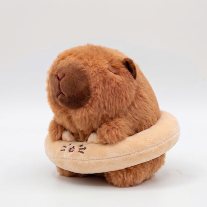 Cute capybara plush wearing a cat floatie 