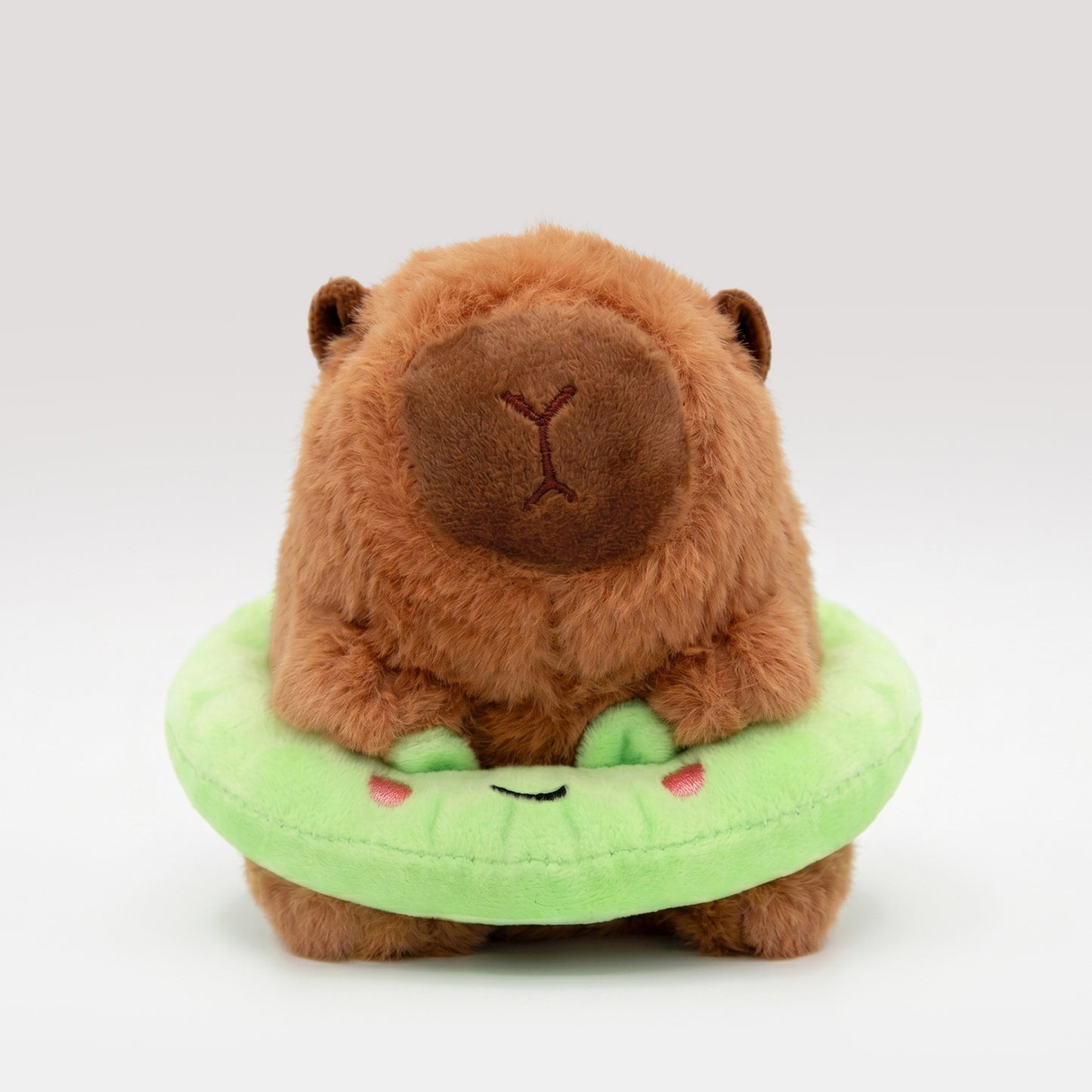 Soft Capybara plush wearing a bright green frog floatie