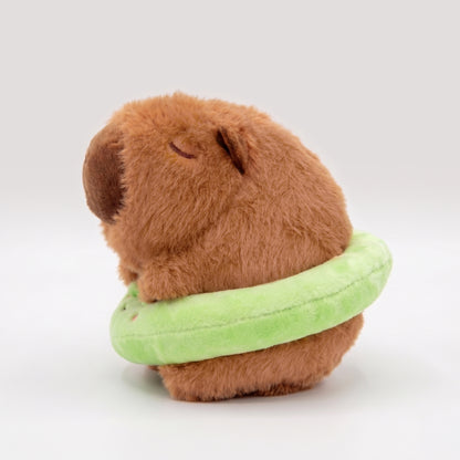 Back view of soft Capybara plush wearing a bright green floatie with a frog face