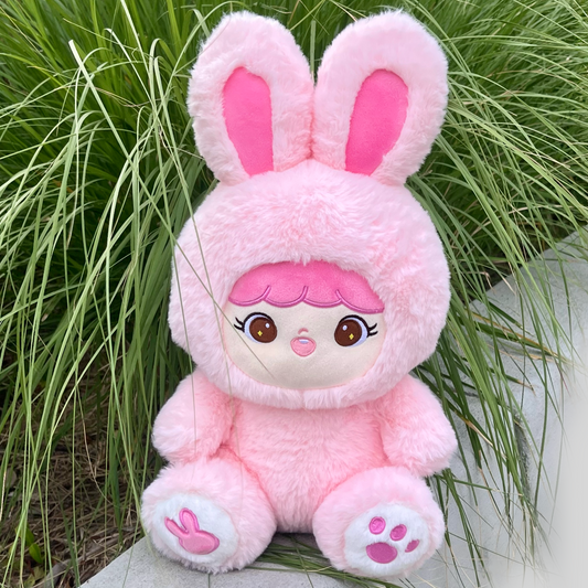 Shoobi sitting in lifestyle setting in front of green plant